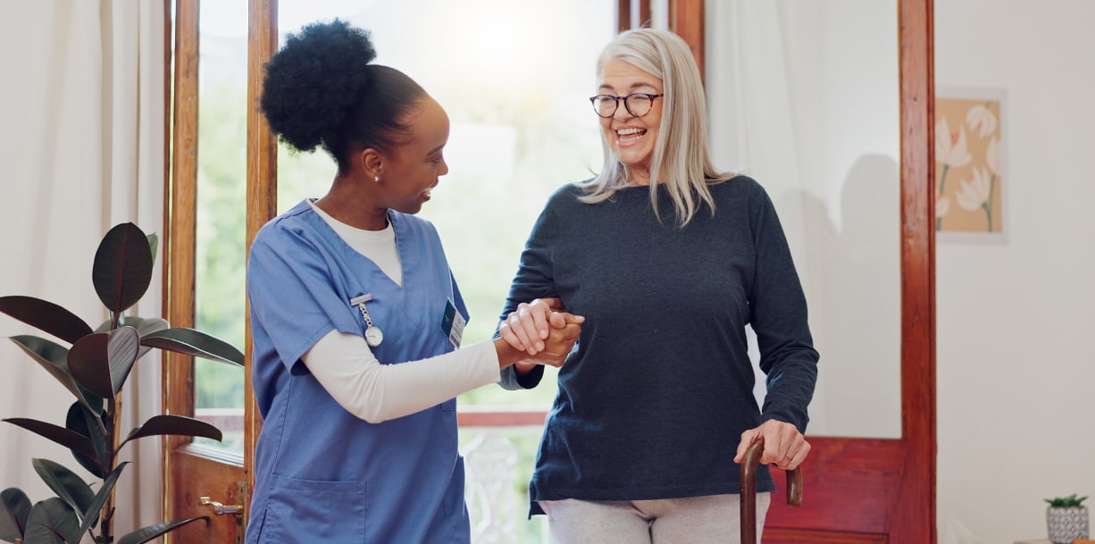 A nurse helping a woman walk