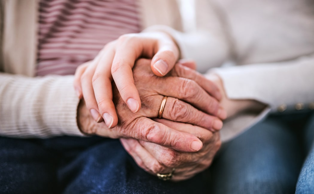 Two sets of hands are being held by one another