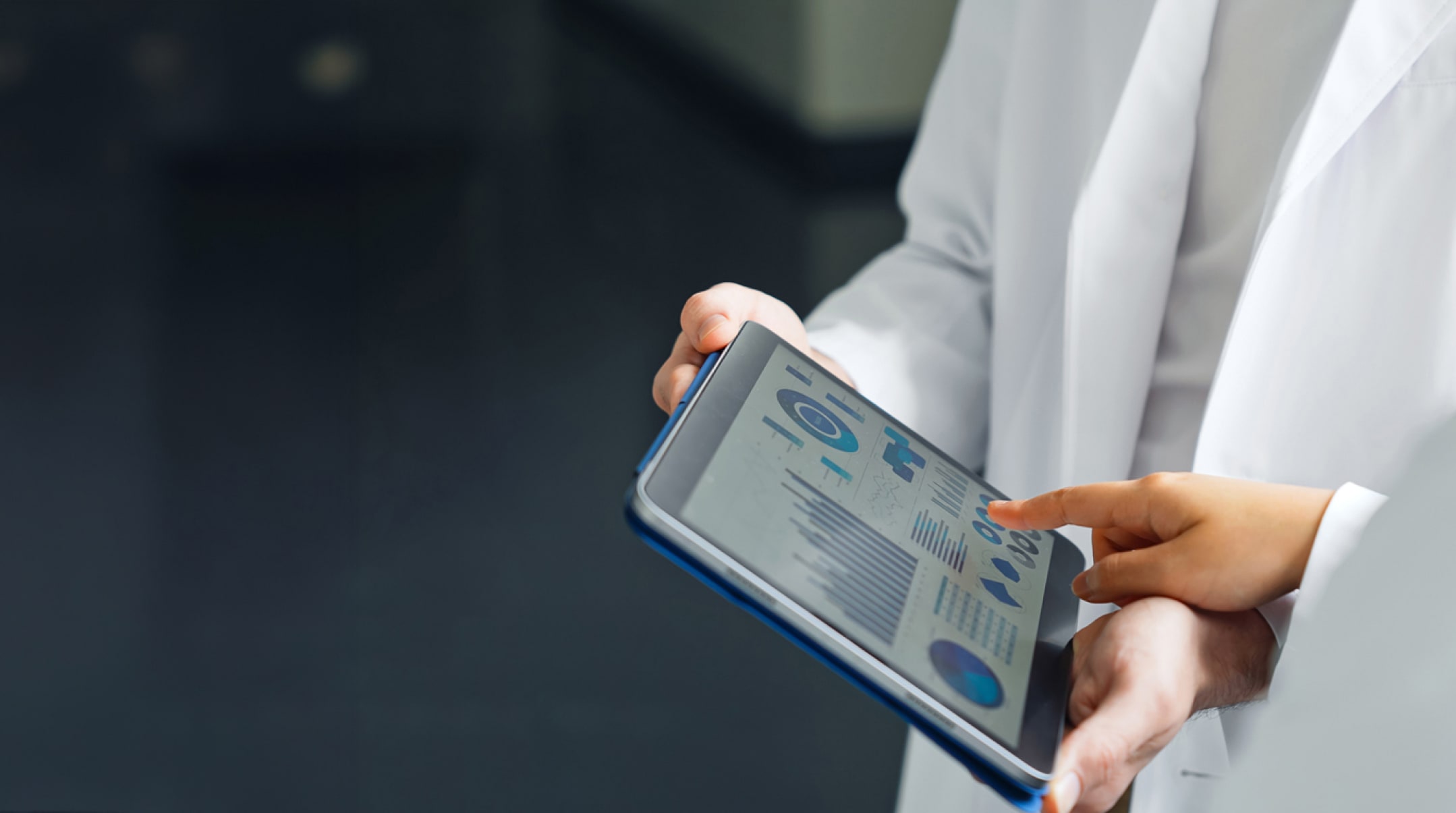 A group of researchers looking at a tablet screen.